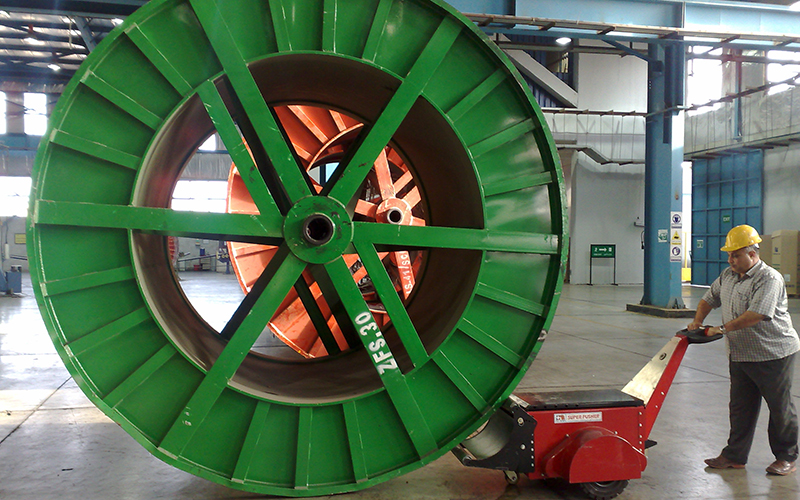DM Super Power Pusher, with Roller Attachment, pushing 40,000Kg cable drum at Elsewedy Cables in drum storage area