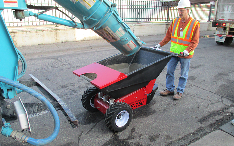 Using the Electric Wheelbarrow to move concrete from roadside delivery truck to internal small works