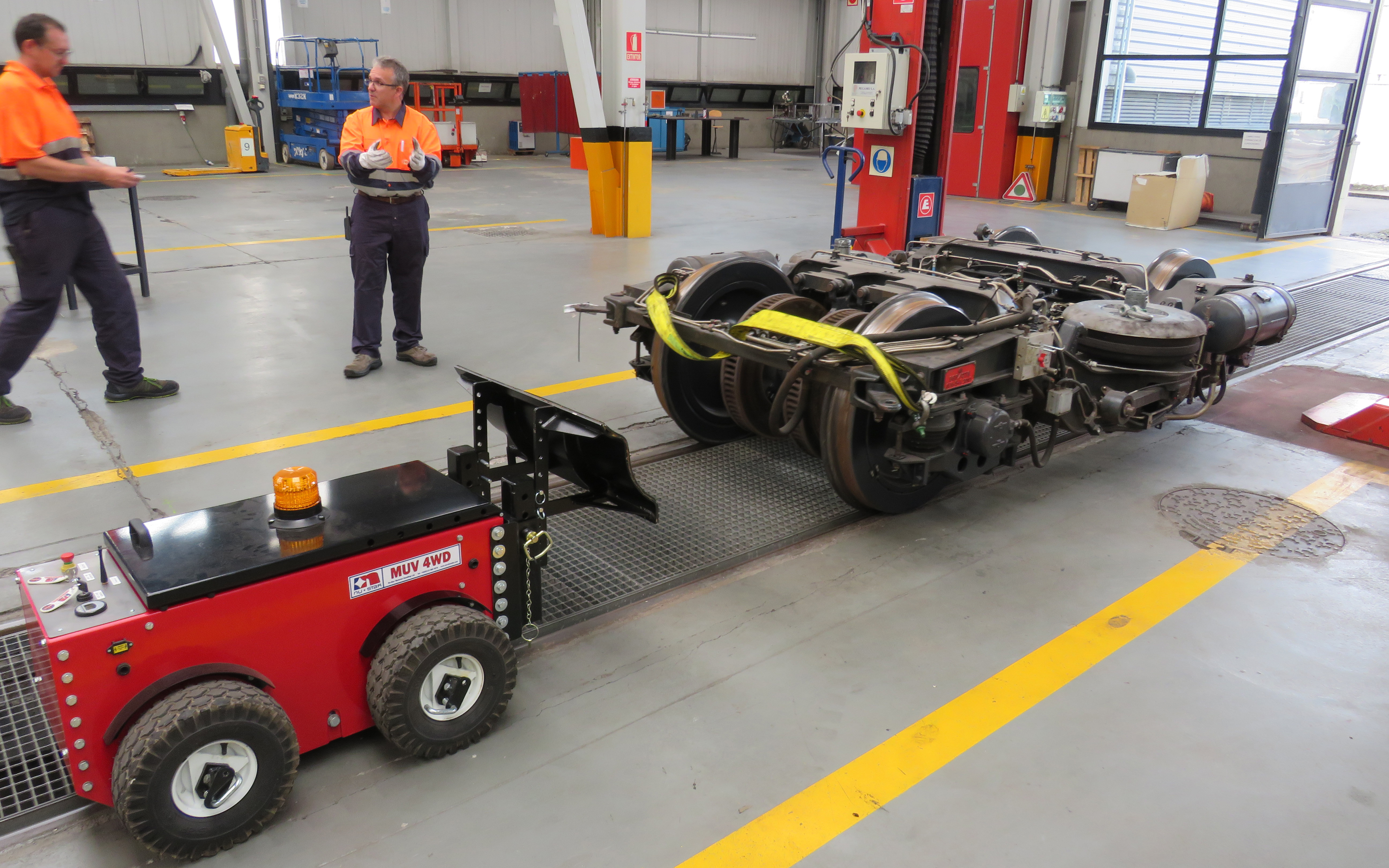 Radio controlled MUV 4WD electric tug being used for moving metro rail bogies in maintenance workshop