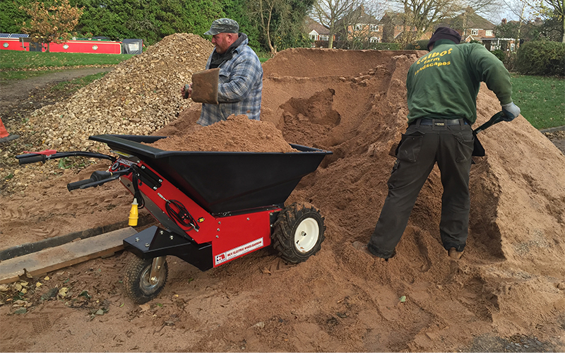 Using the Electric powered Wheelbarrow to move sand during a turfing project