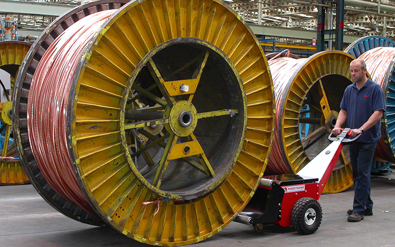 Power Pusher, with Roller Attachment, pushing cable drums at Prysmian Cables