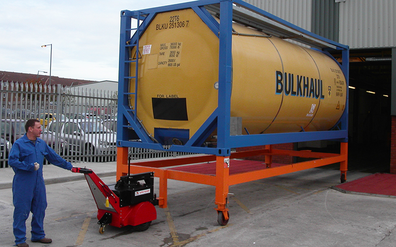 Super Power Pusher with Steering Arm moving chemical ISO container into and out of wash bay for Bulkhaul