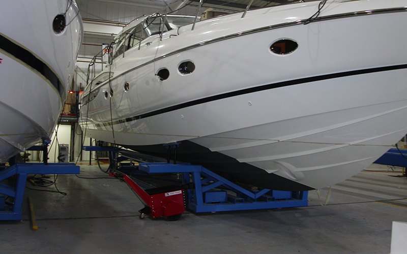 Super Power Pusher moving yacht cradles linked together on a production line